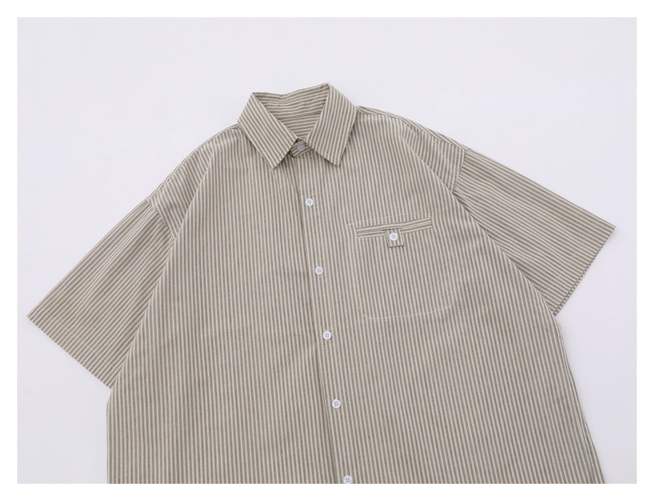 Front of a light beige striped short-sleeve button-up shirt with a pointed collar and buttoned chest pocket.