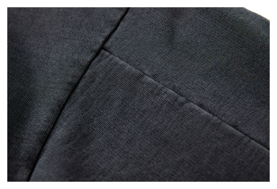 Macro view of dark hoodie fabric and a stitched seam.