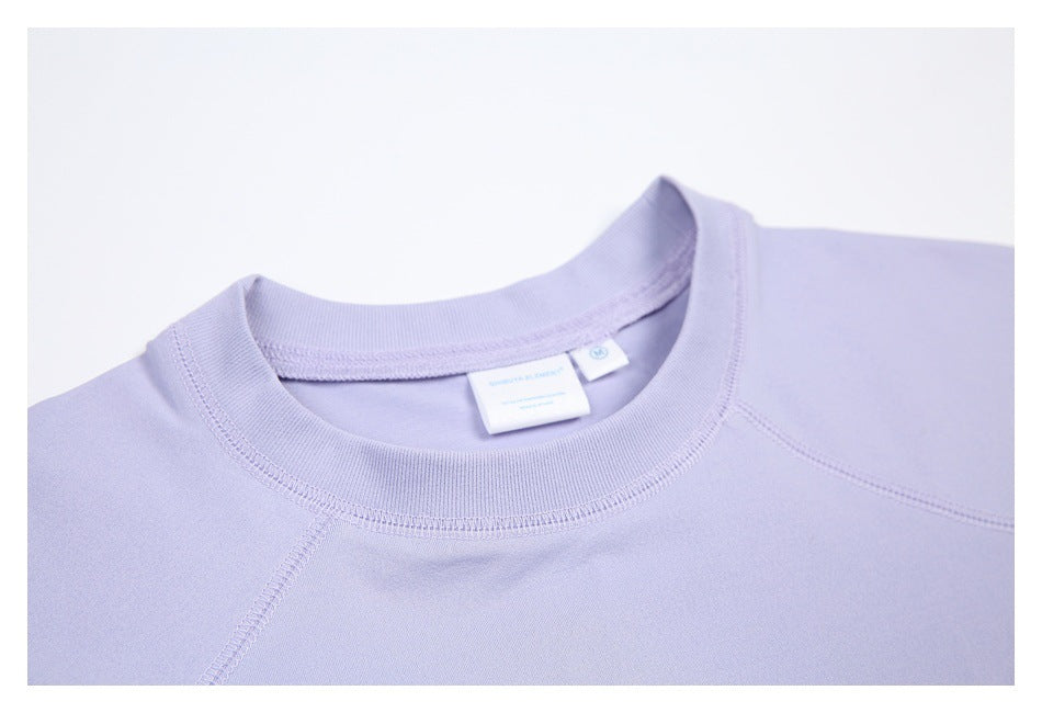 Close-up of the lavender shirt’s ribbed crew neck, collar stitching, and inner label.