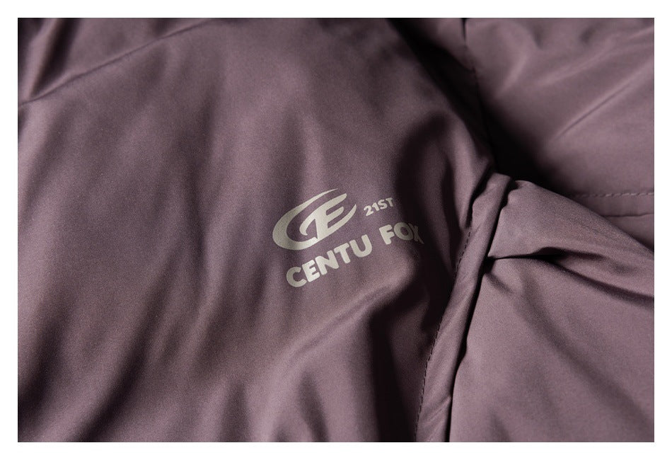 Close-up of a pale logo printed on the mauve jacket beside a sleeve seam.