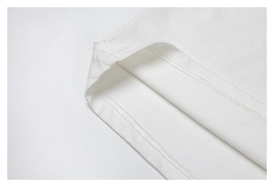 Close-up of a white garment hem with visible overlock stitching and folded fabric.