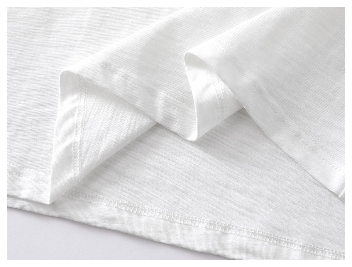 Close-up of the white T-shirt hem and visible stitching.