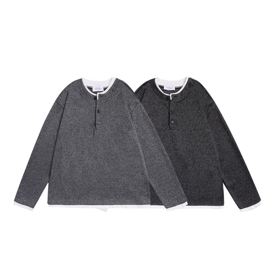 Two long-sleeve tops shown from the front in medium and dark charcoal, with white trim and short button plackets.