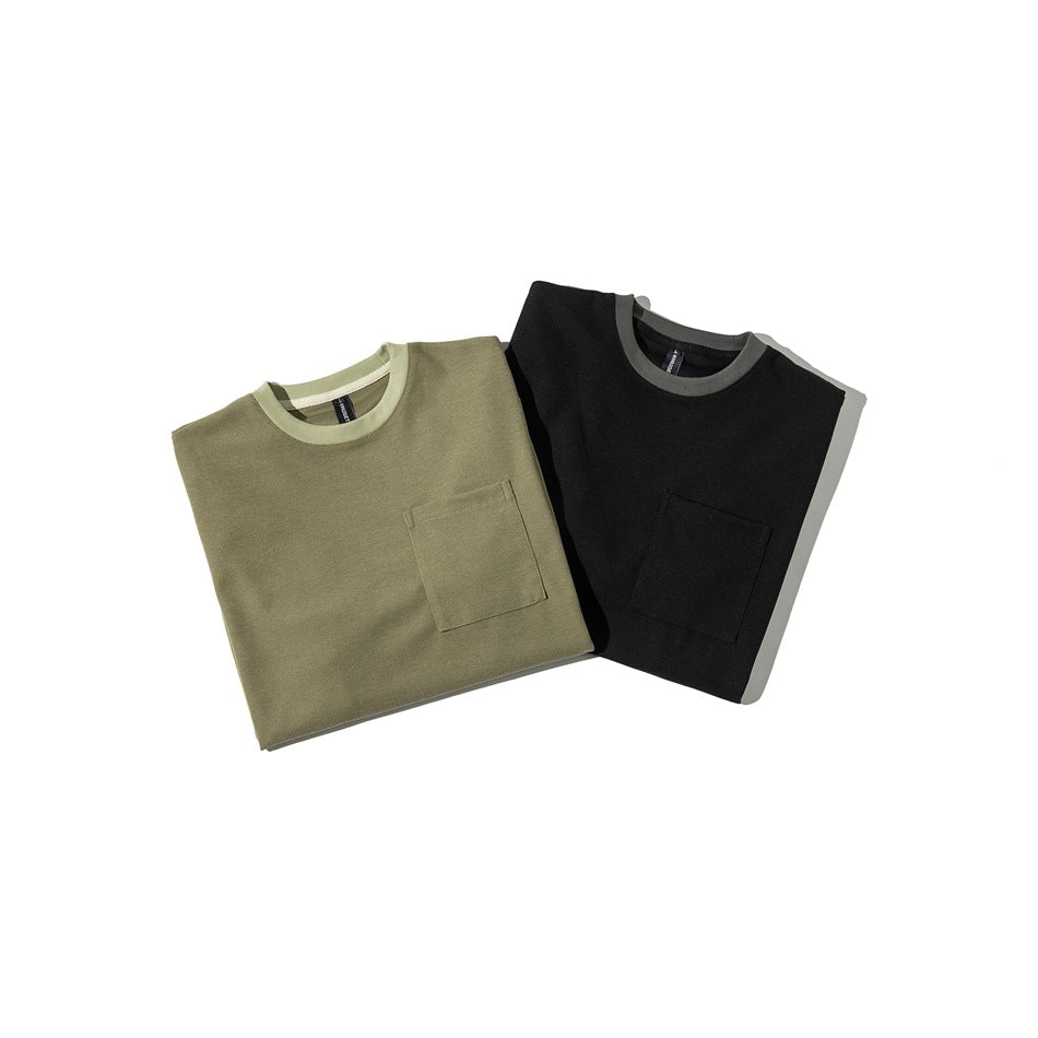 Two folded short-sleeve crew-neck shirts with chest pockets, in olive green and black.