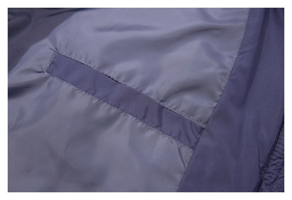 Close-up of the slate-blue garment's interior seam and stitched reinforcement strip.