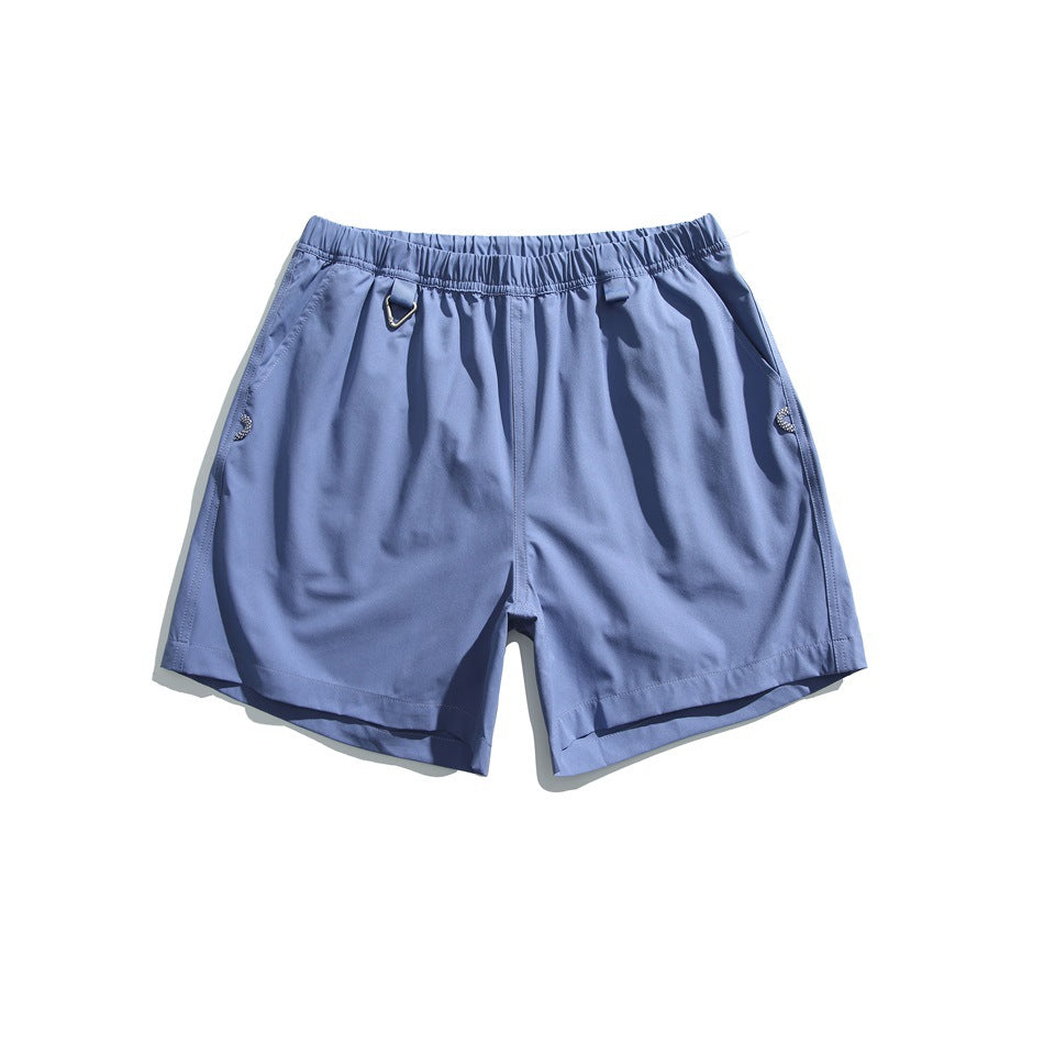Blue shorts with an elastic waist, side pockets, and a small metal ring at the waistband.