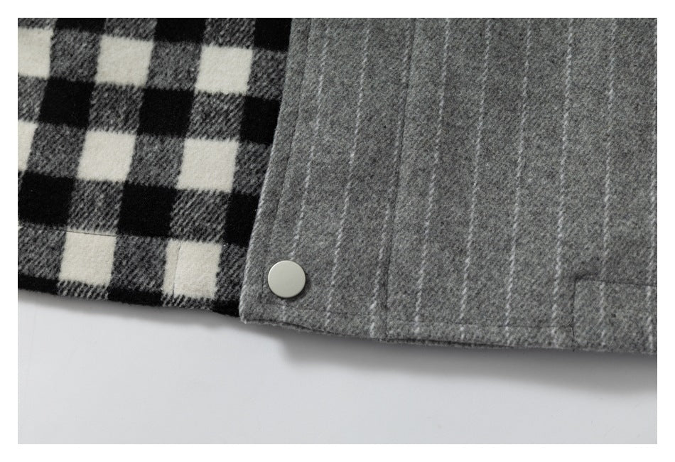 Close-up of a gray garment edge with a silver snap beside black, gray, and white check fabric.