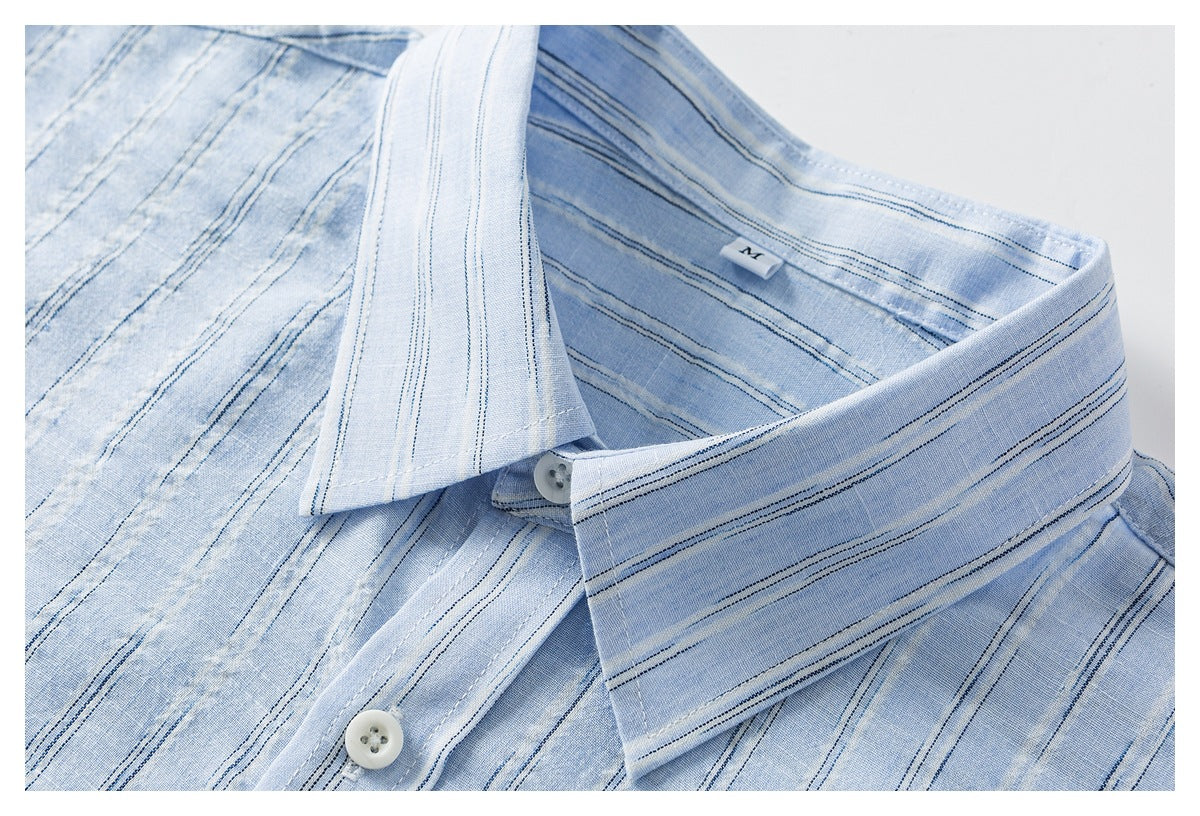 Close-up of a light blue striped shirt collar, placket, white buttons, and inner size label.