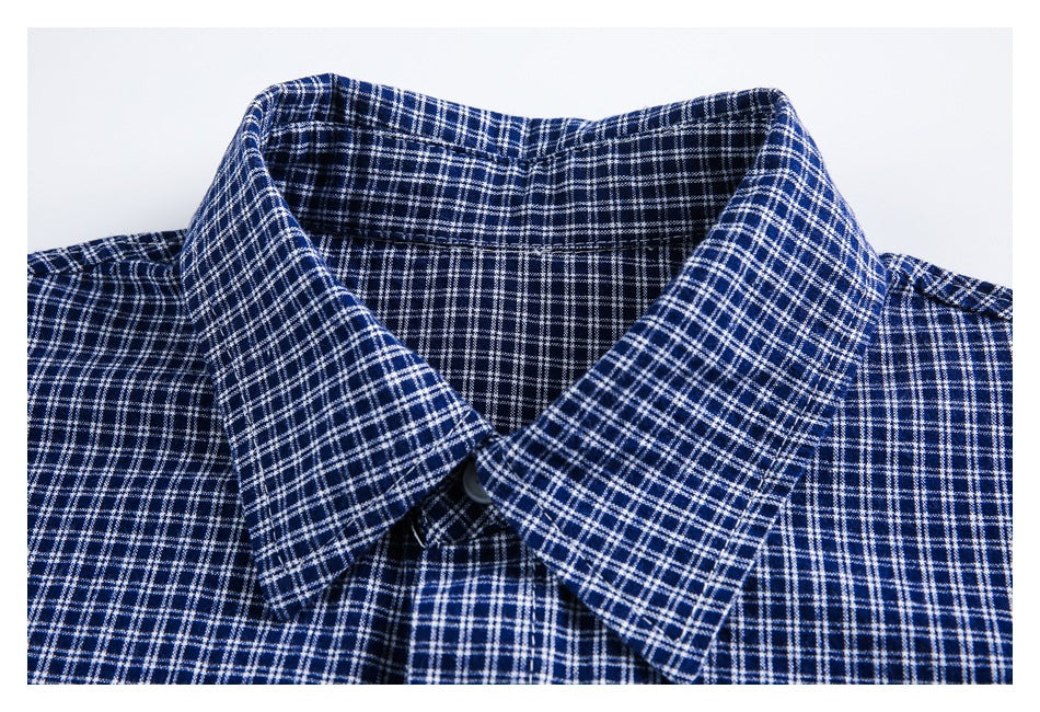 Close-up of a pointed collar on a navy shirt with a white windowpane check.