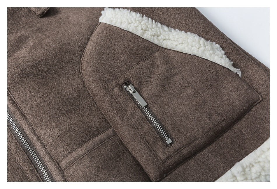 Close-up of a brown jacket pocket with a vertical metal zipper and cream fleece trim above it.