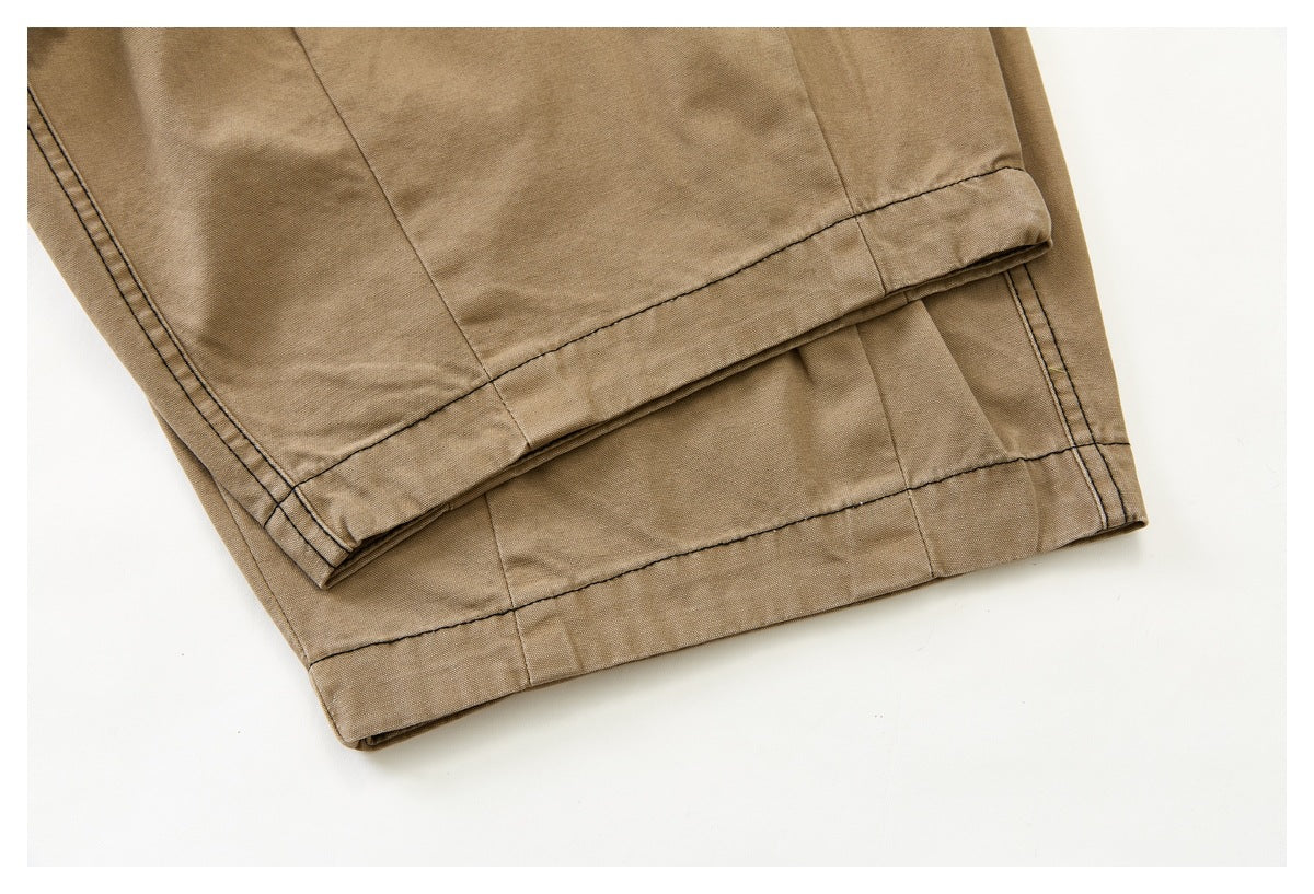 Close-up of the tan pants' stitched, folded leg hem.