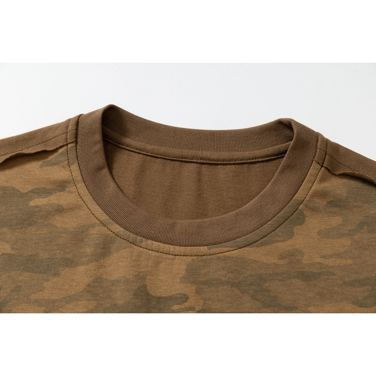 Close-up of a brown crew neck and shoulder seams on a brown camouflage T-shirt.