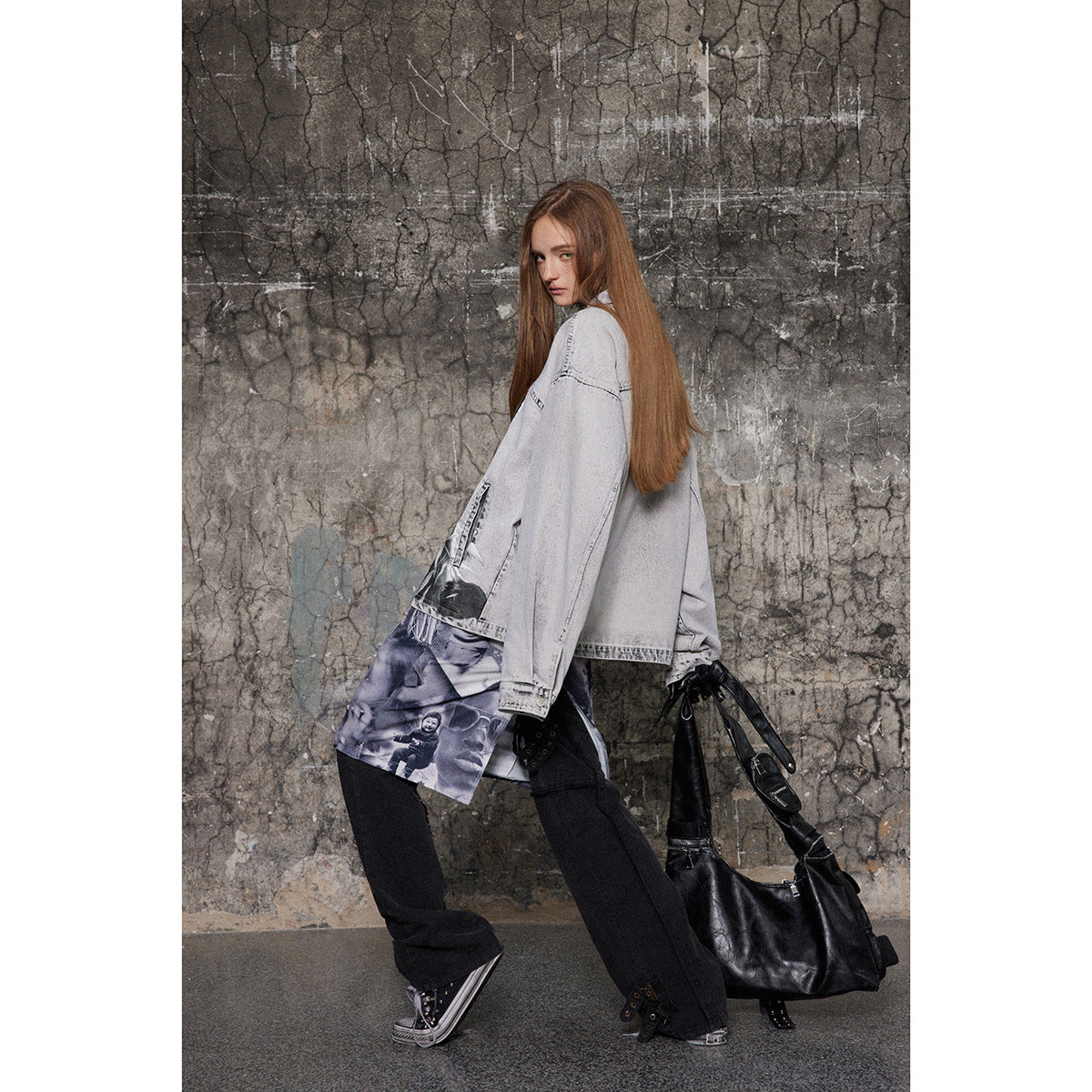 Model in an oversized pale gray jacket, shown from the side and back, with black trousers and a purple graphic layer.