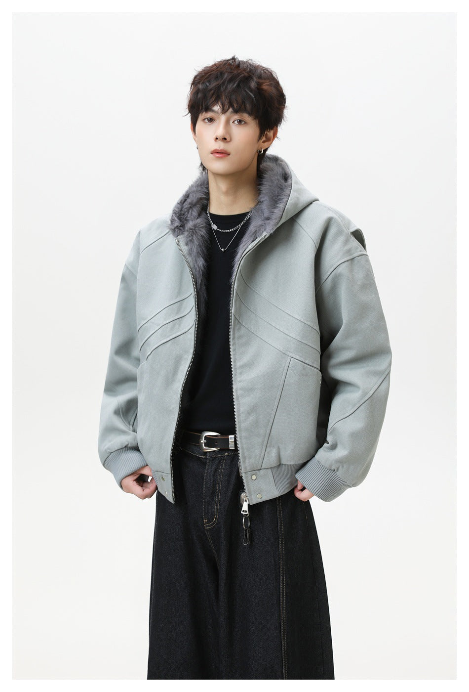 Model wearing gray hooded zip jacket with fleece-like lining over a black top and dark wide-leg jeans