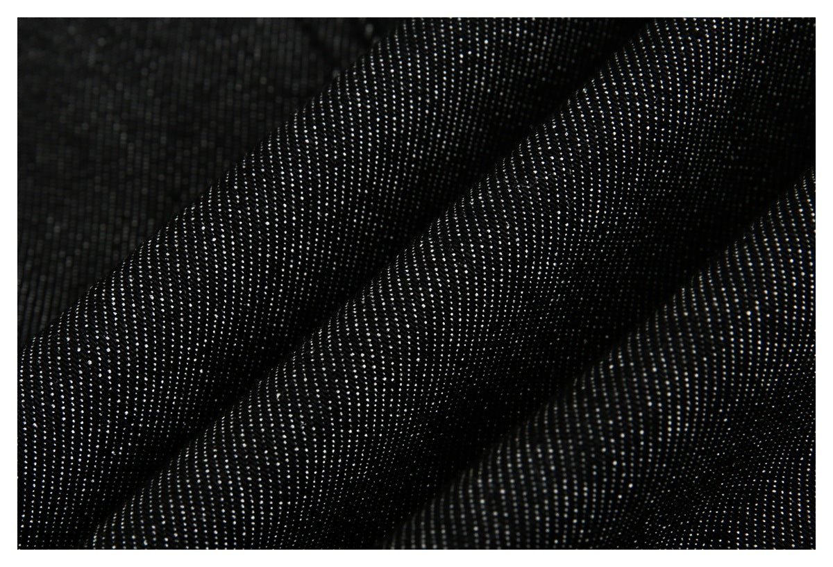 Macro view of black fabric with a fine, visibly textured weave.
