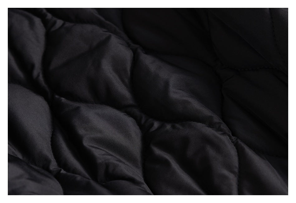 Close-up of black quilted jacket lining with stitched padded sections.