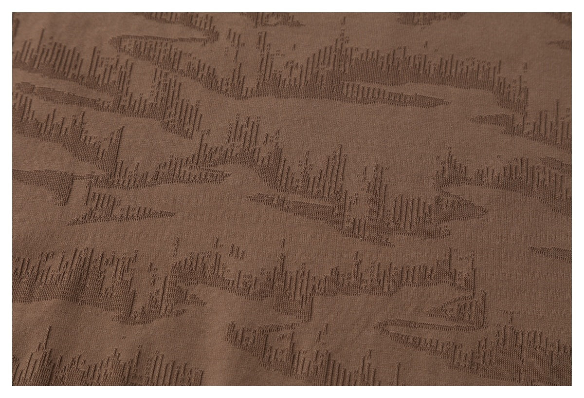 Close-up of brown fabric showing an all-over raised geometric texture.