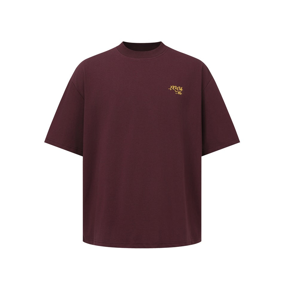 Burgundy short-sleeve T-shirt with a small yellow script design on the chest.
