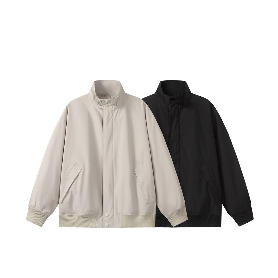 Front view of two stand-collar jackets, one light beige and one black, with ribbed cuffs and hems.