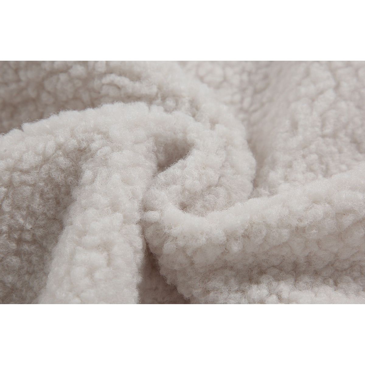Extreme close-up of the jacket's soft, fluffy ivory lining.