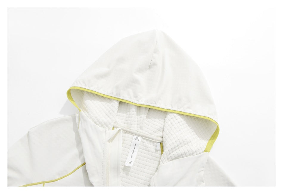 Close-up of the white jacket's hood lining, yellow piping, and interior neck label.