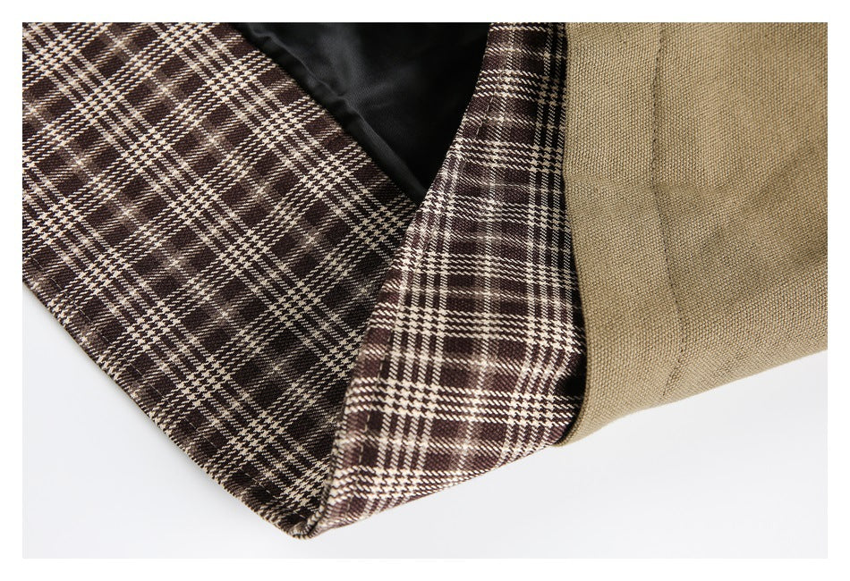 Close-up of the jacket's brown plaid lining, black inner lining, and khaki outer fabric.