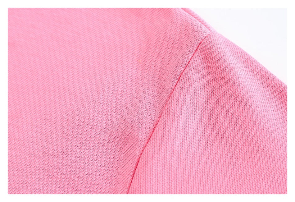 Close-up of the pink sweatshirt’s shoulder seam and textured fabric.