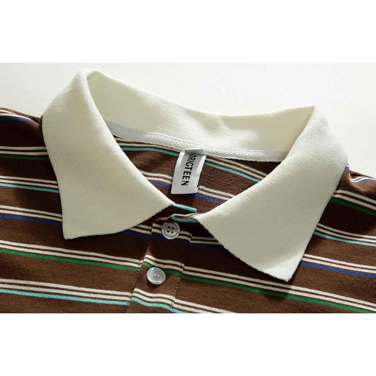 Close-up of a brown striped polo shirt with a cream collar, buttons, and a visible neck label.