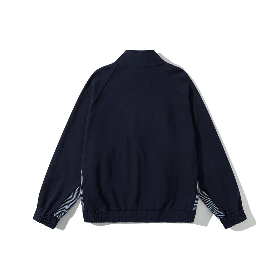 Back view of a navy stand-collar jacket with raglan sleeves, striped side panels and elastic cuffs and hem