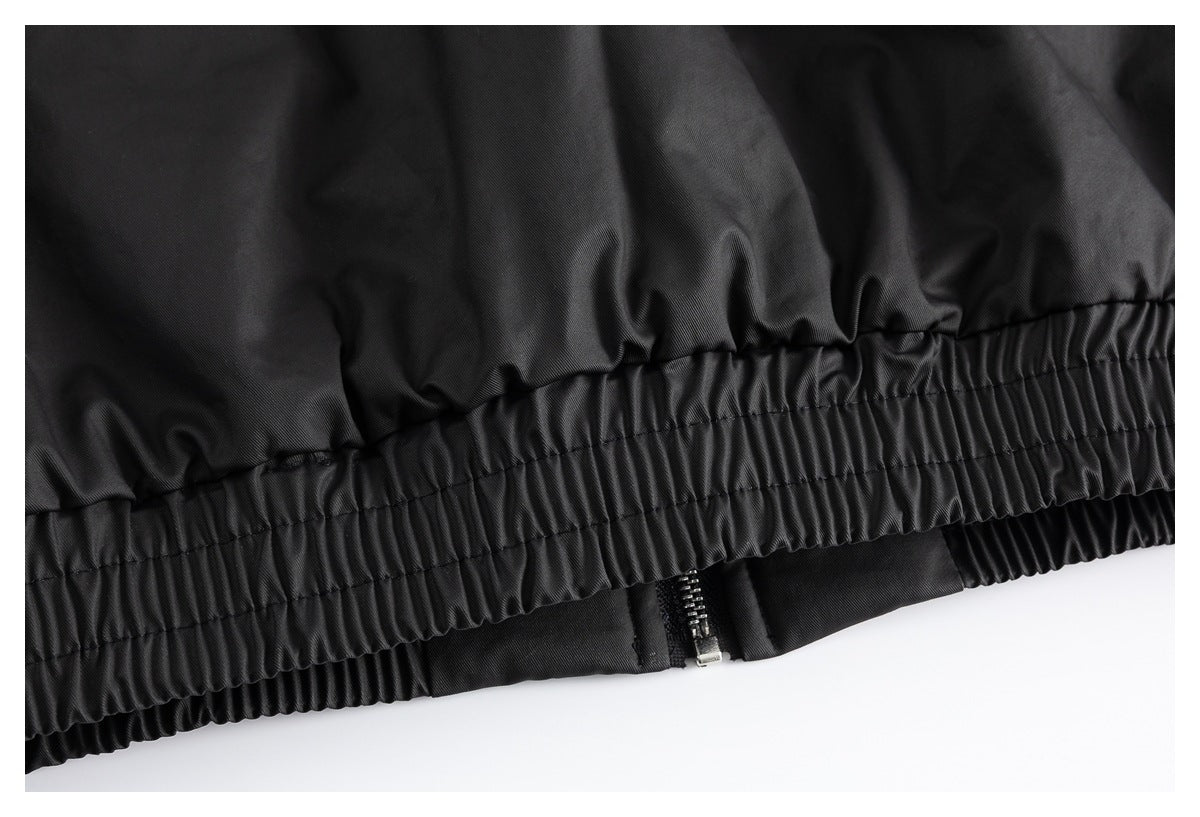 Close-up of a black garment’s gathered elastic band with a small zipper visible beneath it.