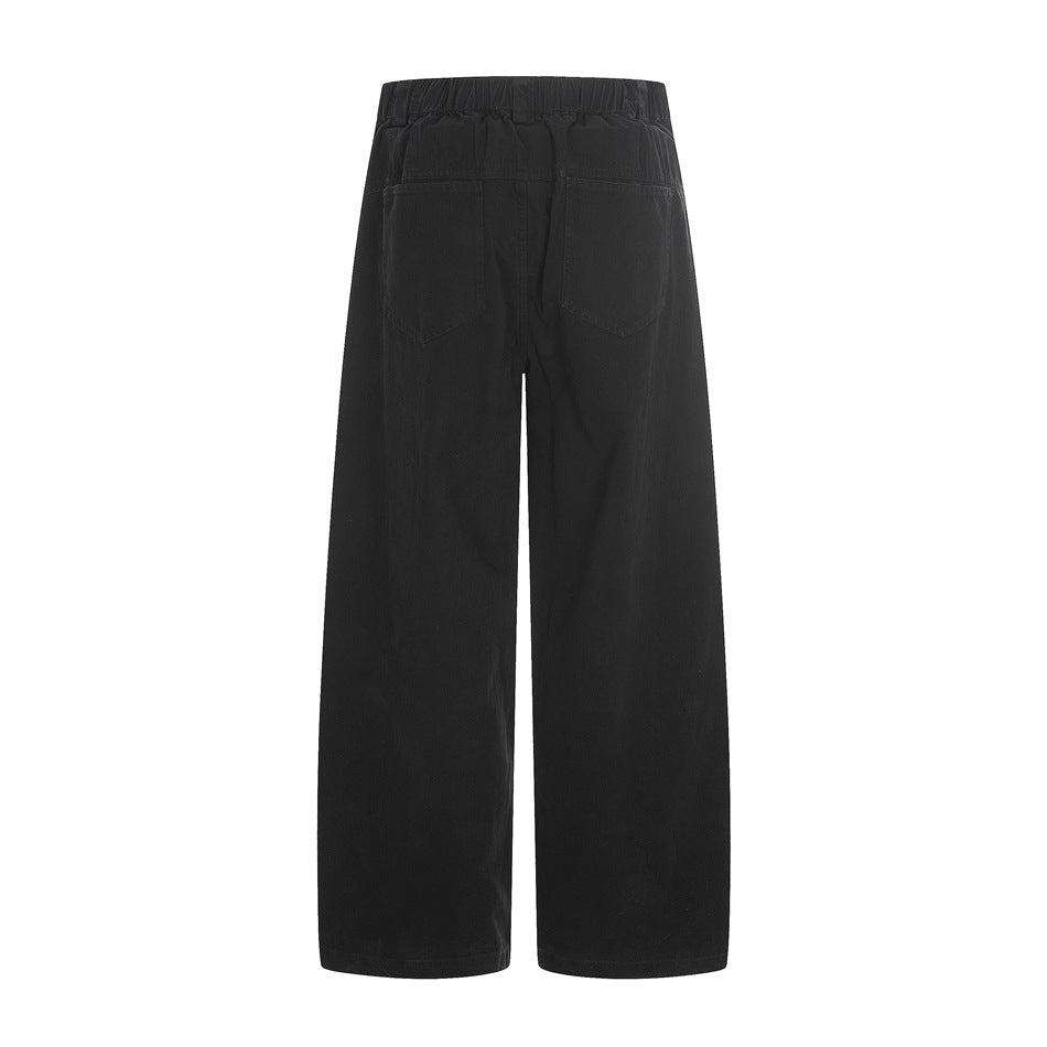 Back view of black wide-leg pants with an elastic waistband and two rear patch pockets, shown on a white background.