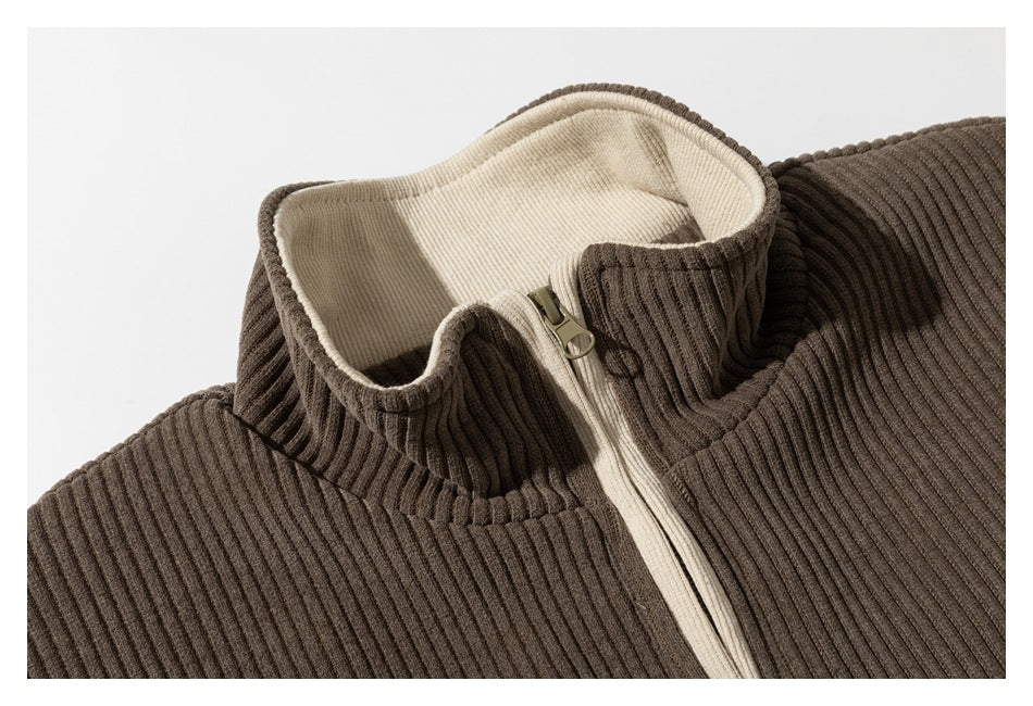 Close-up of a brown ribbed jacket collar with cream lining and a front zipper.
