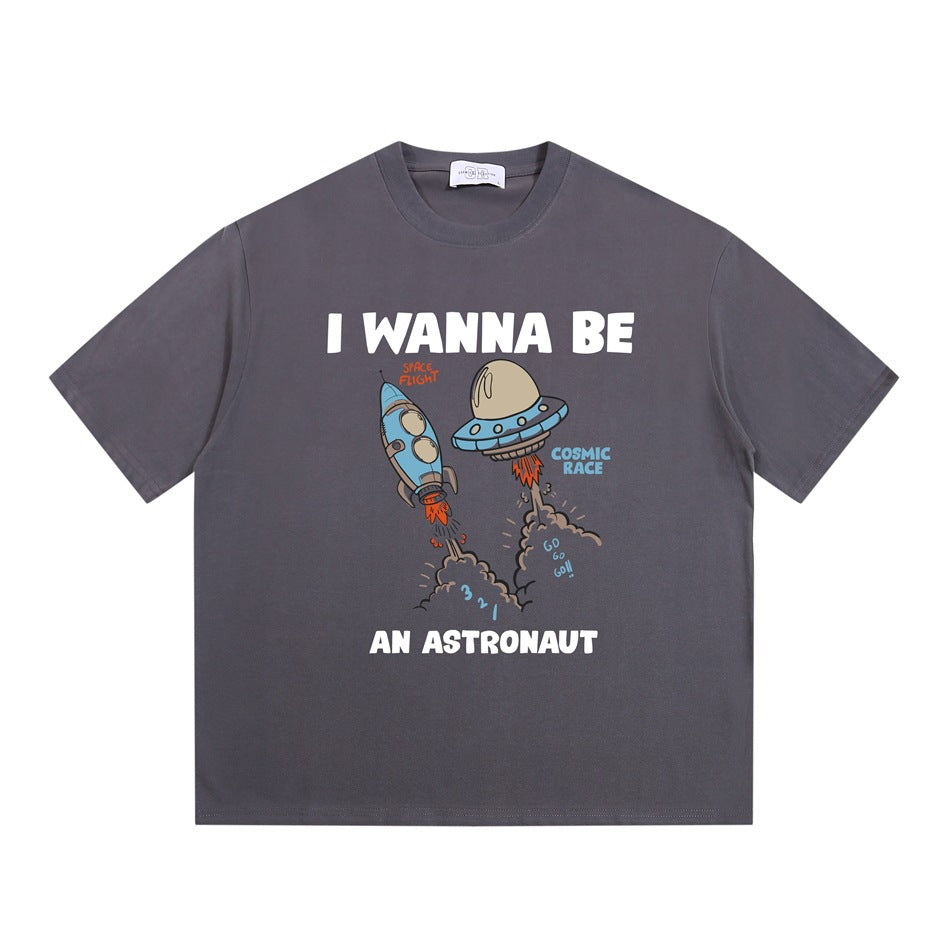 Gray short-sleeve crew-neck T-shirt with cartoon rocket and UFO 'I WANNA BE AN ASTRONAUT' graphic, flat lay
