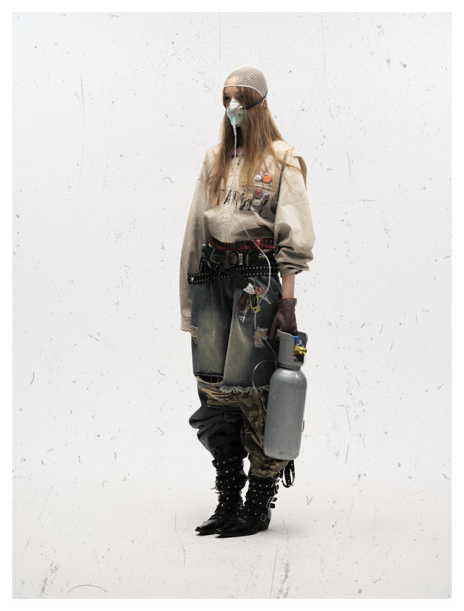 Side view of a model wearing the off-white jacket with chest badges, styled with jeans, belts and studded boots