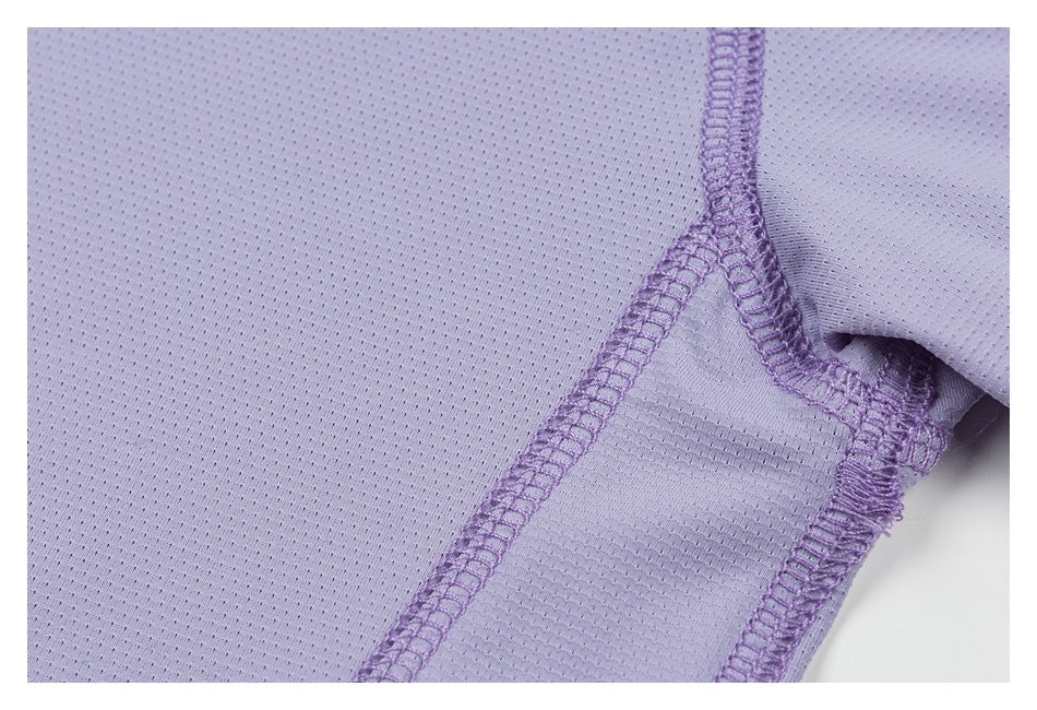 Close-up of a lavender shirt seam and underarm area with purple overlock stitching.