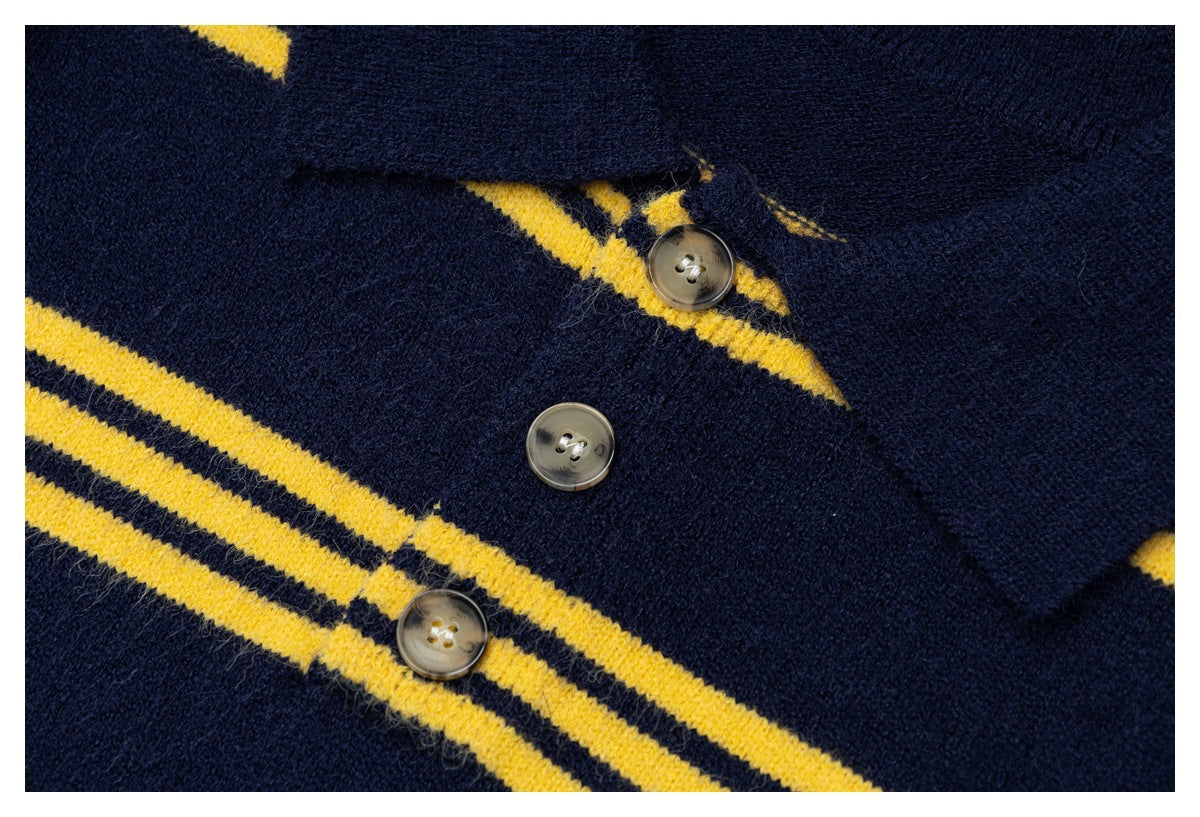 Close-up of a navy knit cardigan placket with translucent buttons and mustard-yellow stripe accents.