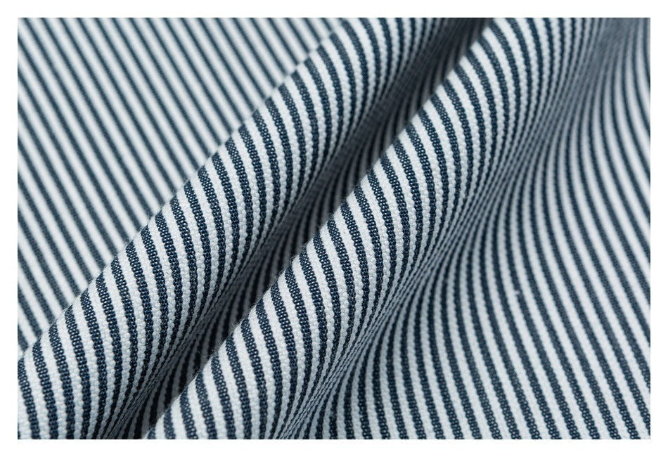 Close-up of folded white fabric with narrow navy stripes in alternating directions.
