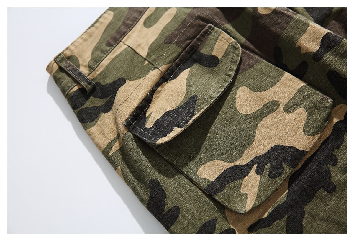 Close-up of a large flap pocket and stitching on camouflage trousers.