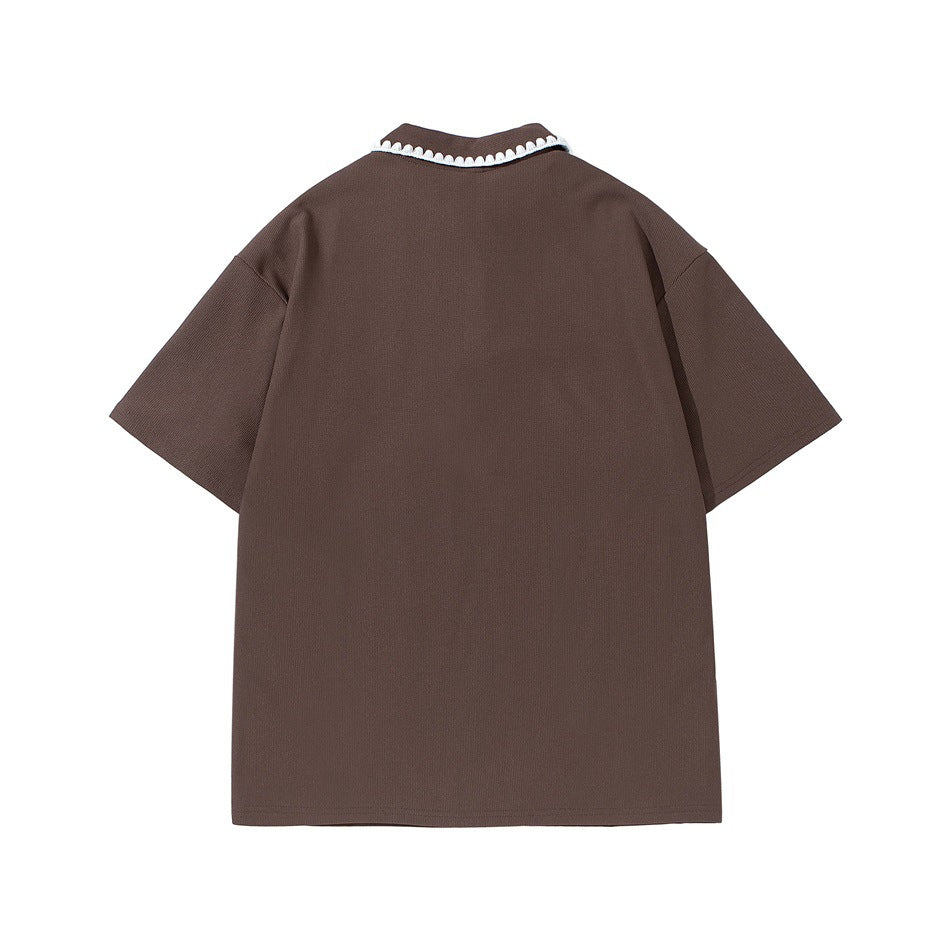 Back view of a brown short-sleeve polo shirt with contrasting white scalloped trim along the collar.