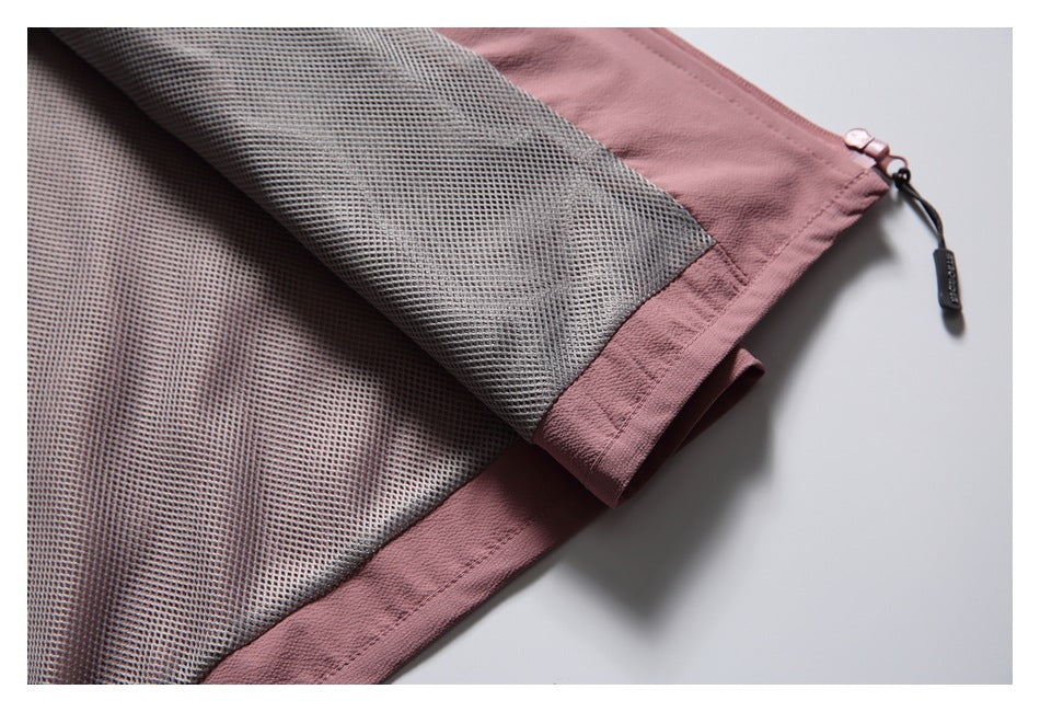 Close-up of the vest's gray mesh lining, dusty rose edging, and adjustable hem cord.
