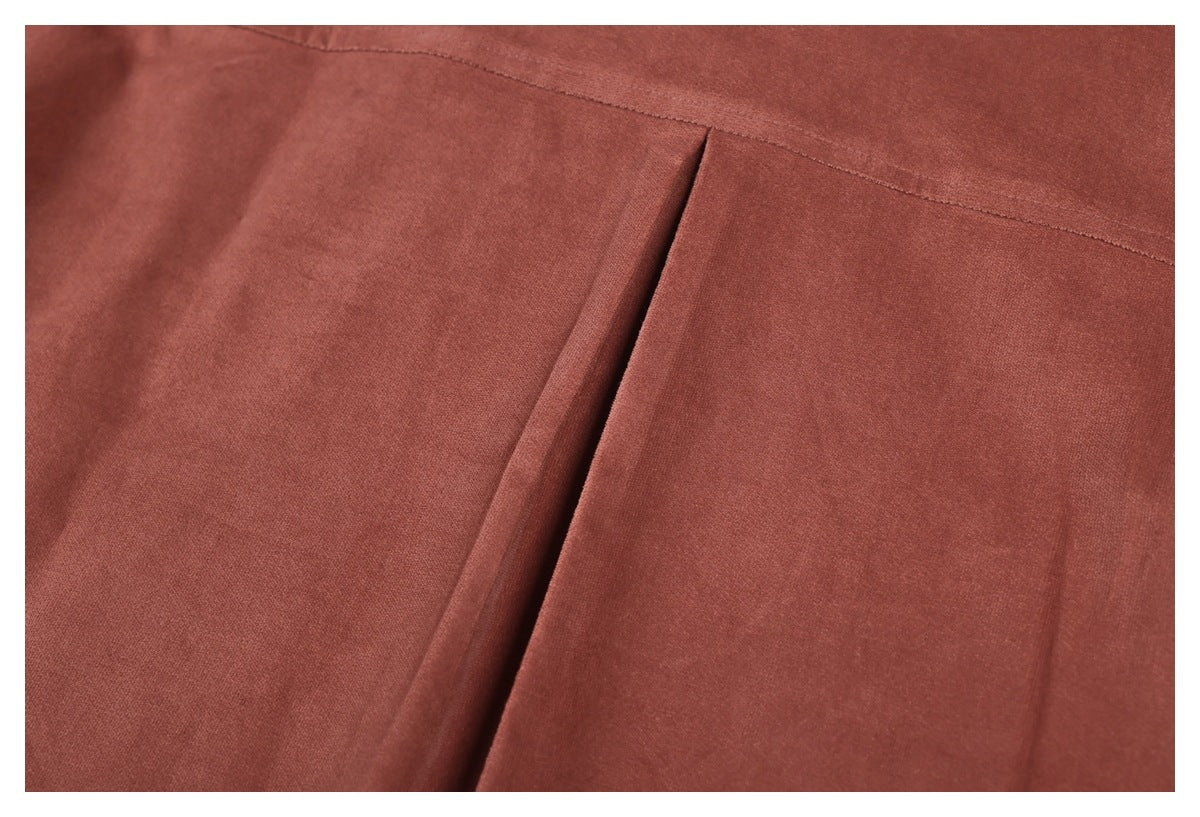 Close-up of the rust-brown shirt back pleat and horizontal yoke seam.