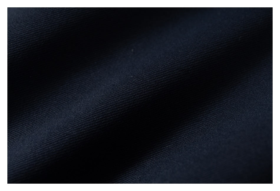Close-up of dark navy fabric showing its fine woven texture.