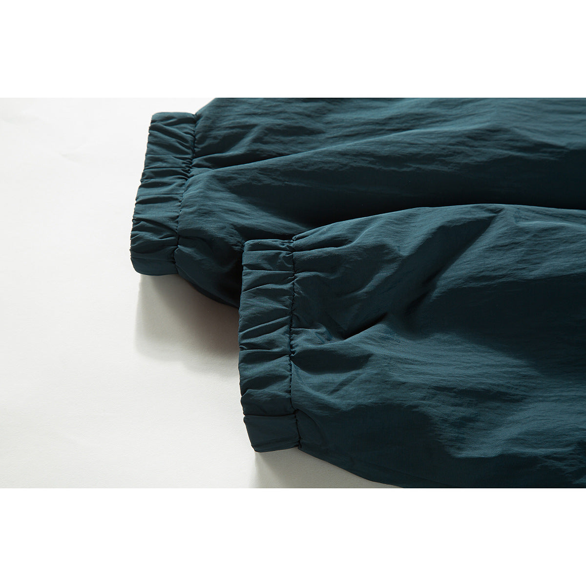 Close-up of the dark teal jacket's gathered elastic cuffs.