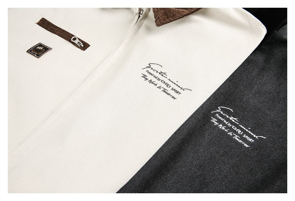 Close-up of ivory and black jacket fronts with small printed designs and a brown zipper detail.