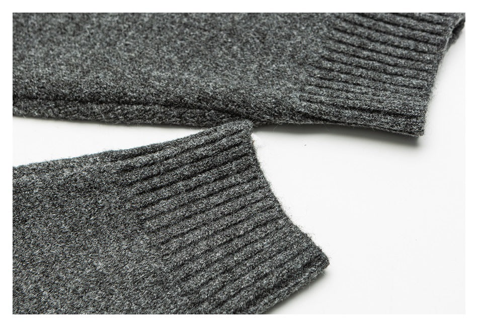 Close-up of the charcoal sweater's ribbed sleeve cuff and knit texture.
