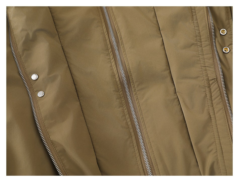 Close-up of the khaki jacket's layered front zipper closures and silver snaps.