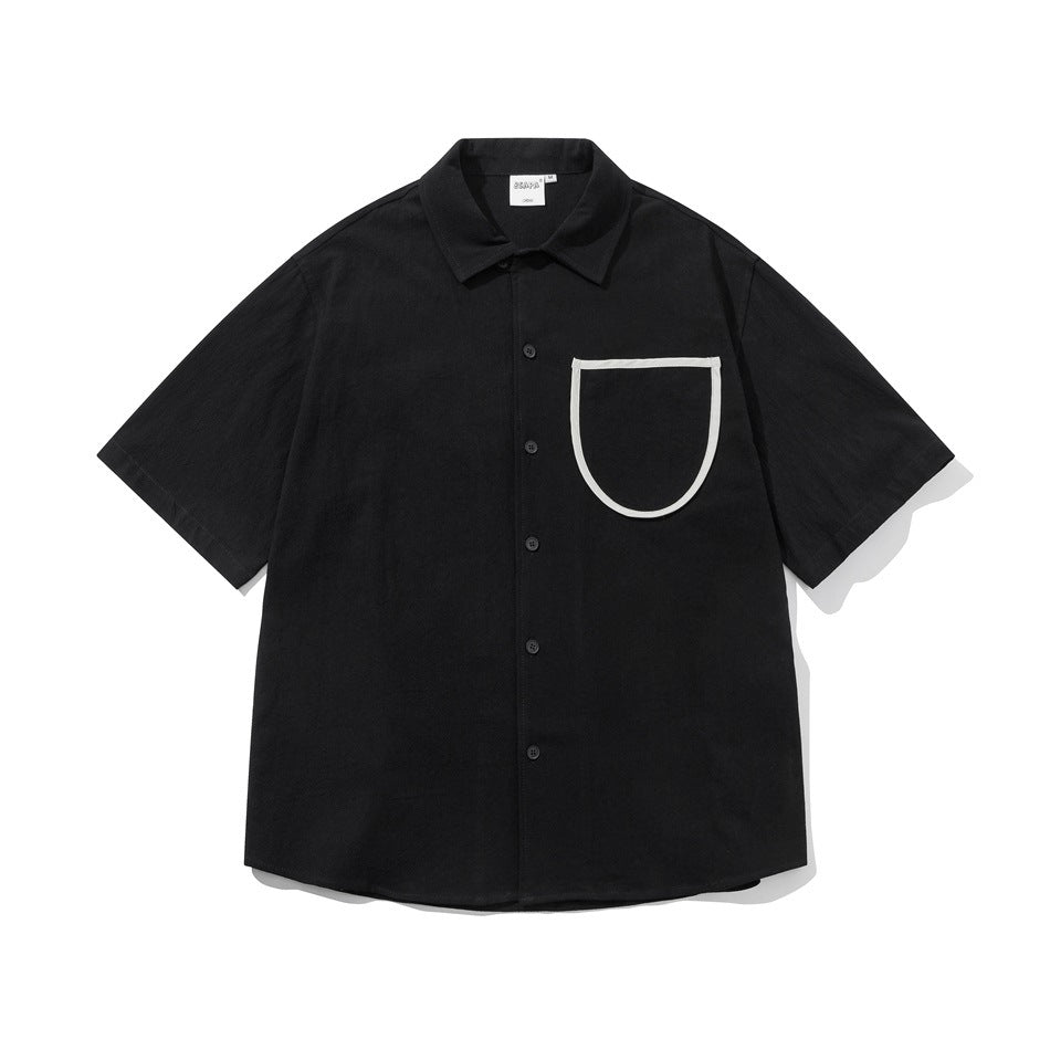 Black short-sleeve button-up shirt with a large U-shaped chest pocket trimmed in white piping, flat lay