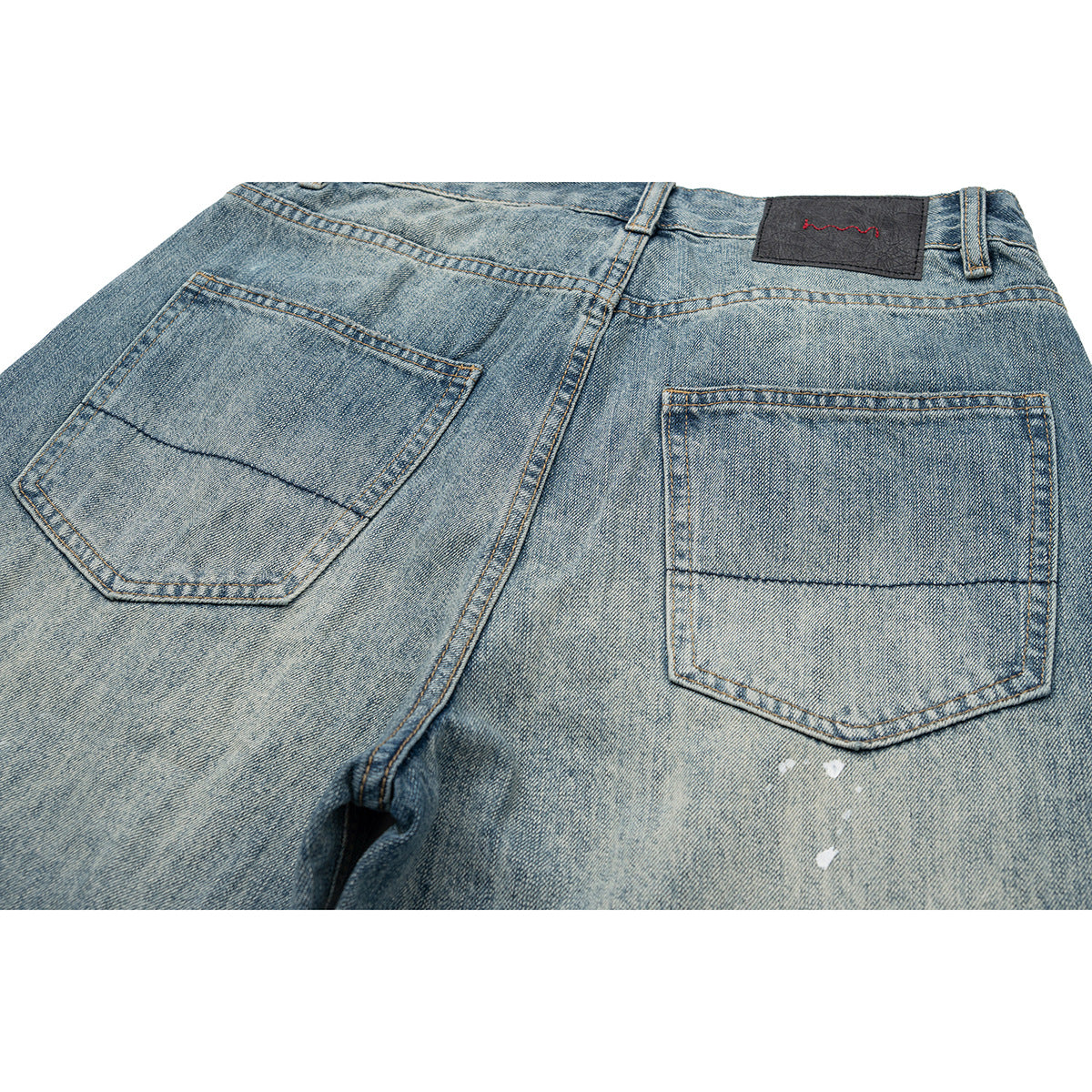 Close-up of the back of faded blue jeans, showing two pockets and a dark waistband patch.
