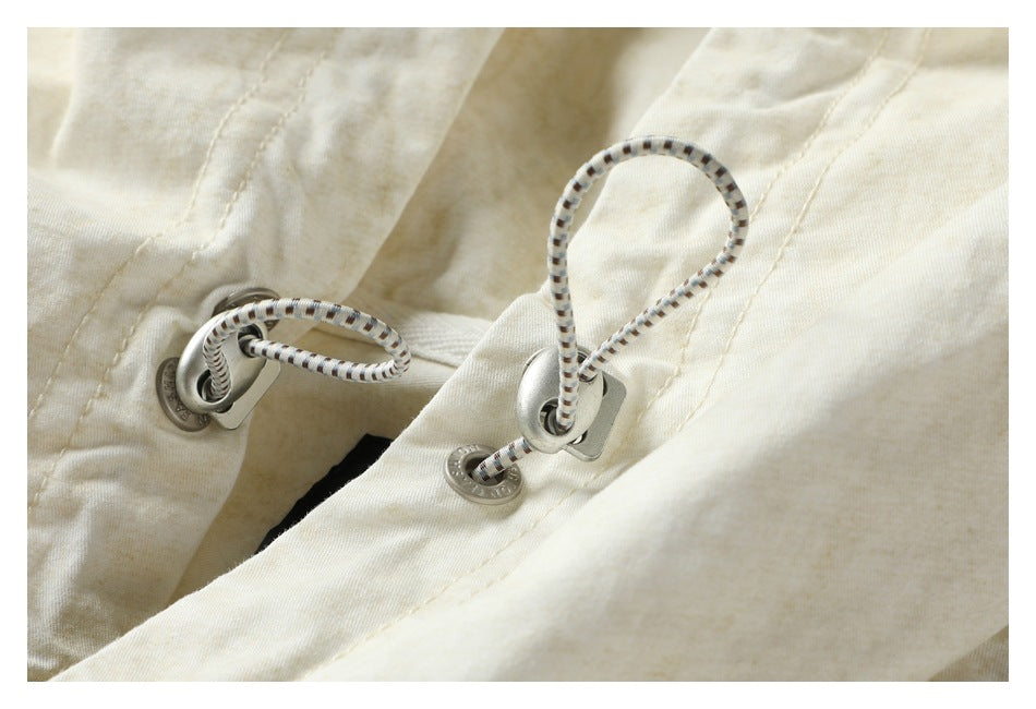 Close-up of the shirt's hood drawcords threaded through metal eyelets.