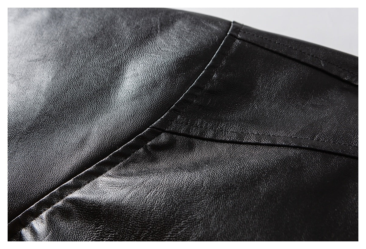Close-up of the black jacket's pebbled surface and stitched panel seams.